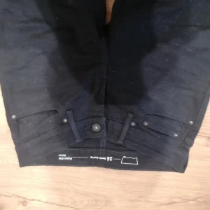 Svarta Levi's Demi Curve skinny jeans - Svarta skinny jeans från Levi's Demi Curve med modern midja. Klassisk femficksdesign, knapp och dragkedja framtill samt diskret Levi's-logga på bakfickan. Jeansen är tillverkade i stretchigt denim för en tajt och bekväm passform.                                             Endast använd två gånger, sedan hängt i garderoben. 