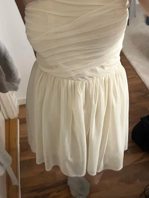 kräm vit kortklänning - Säljer denna klänning från jeane blush, i väldigt bra skick