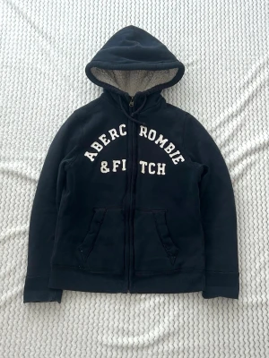 Abercrombie & fitch zip hoodie med foder  - En zip från Abercrombie & fitch i storlek M (HERR). Mått på bilder. Jag fraktar inom 24h, PostNord prioriteras. Se liknande plagg i min profil!