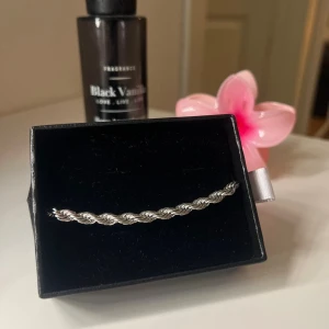 Tvinnat silverarmband i box - Snyggt tvinnat armband i silverfärg, levereras i svart presentask. Armbandet har en stilren och modern design med tvinnad kedja som ger en cool och trendig look. Perfekt att matcha med andra smycken för en personlig stil.