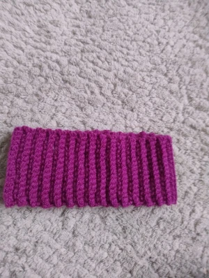 Ribbat handgjort virkat lila pannband - Snyggt ribbat virkat pannband i lila som jag gjort själv . Perfekt för dig som vill ha något enkelt men ändå sticker ut. Mjukt och stretchigt material som sitter skönt runt huvudet.