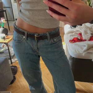 Weekday arrow low straight jeans - Stilrena weekday jeans i ljusblå denim med raka ben och normal passform. Jeansen har fem fickor, knappgylf och tydliga sömmar. Snygg vintagekänsla med en smått randig jeanstvätt. Storlek W27 L32. Lite slitna längst ner på benen för att de har varit lite långa för mig, men det tycker jag har blivit en cool detalj!