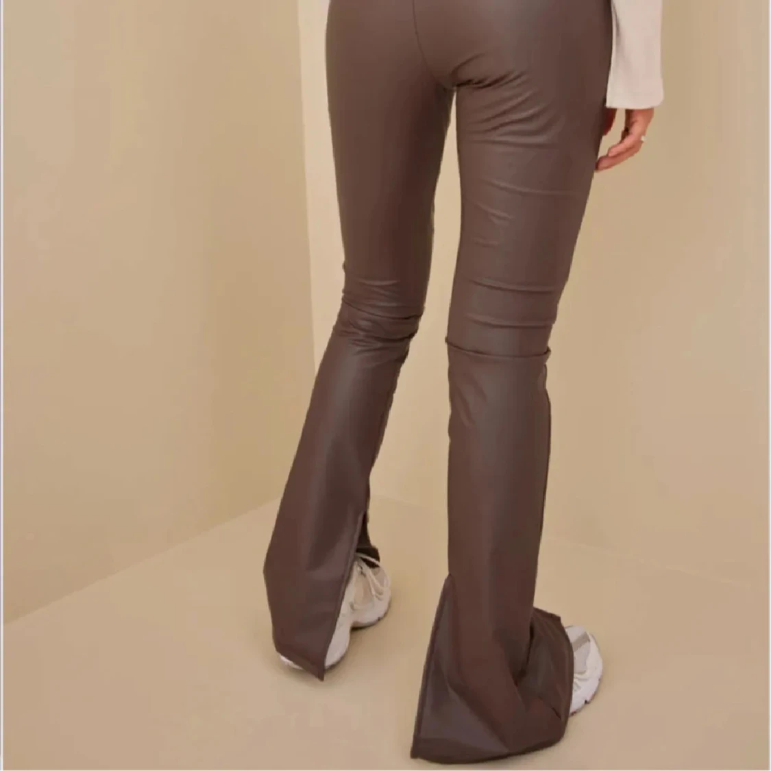 Bruna bootcut byxor i skinnimitation