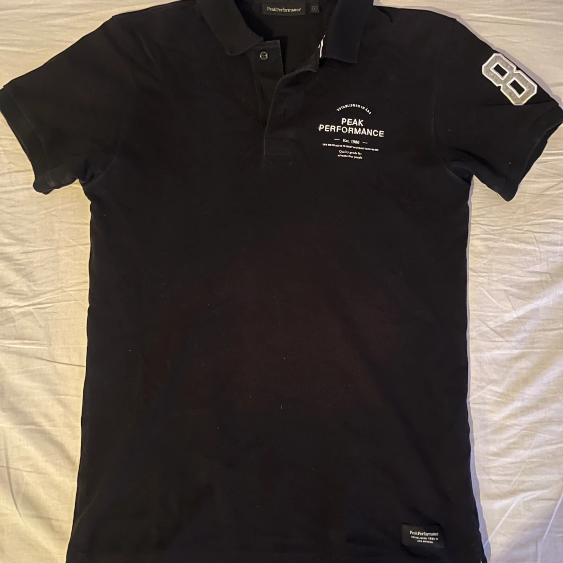 Svart pikétröja Peak Performance