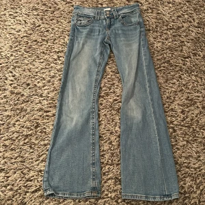 Ljusblå bootcut jeans  - Snygga ljusblå jeans med bootcut passform och klassiska fem fickor. Jeansen har kontrastsömmar samt dubbla knappar i midjan. Perfekta för dig som gillar en stilren vibe💗