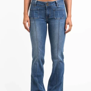 Blå bootcut jeans med fickor - Madlady Claire 01 Low bootcut jeans i längden Extra-Tall (90cm innersöm) storlek 34. Passar mig som är 182 cm lång. Dragkedjan har gått sönder och behöver bytas. Går att fixa hos en skräddare för 100-150kr. Utöver det är byxorna i mycket fint skick!