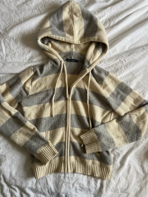 Brandy Melville kofta  - Randig kofta från Brandy Melville i en krämvit och ljusgrå färg🤍 nopprig som syns på sista bilden, annars i fint skick och ingenting jag tycker stör! 