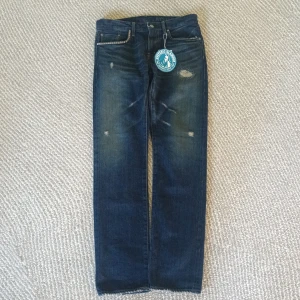 Helt nya Hysteric Glamour jeans - Snygga blå jeans från Hysteric Glamour med coola slitningar och distressed detaljer på framsidan. Japansk denim. Klassisk femficksmodell med raka ben. Märkespatch bak i midjan och metallnitar. Perfekt för dig som gillar en edgy streetstil. DESSA ÄR KÖPTA I TOKYO, JAPAN IN STORE‼️ KVITTO FINNS‼️😎🤑