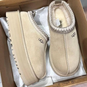Beige UGG boots med plattform - Säljer ett par beige boots från UGG med plattformsula och rund tå. Skorna har  dekorativa sömmar runt öppningen. Perfekta för kalla dagar.Skriv för fler bilder Orignalpris är 2000💕 första bilden är med flash de andra är utan😊