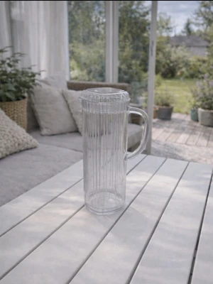 Genomskinlig tillbringare 1,7L från Biltema - En tillbringare från Biltema, med en generös kapacitet på 1,7 liter. Säljs då den inte längre kommer till användning. Den är i hård plast och är i använt skick. Locket har en mindre defekt (se bild), men påverkar inte funktionen. Perfekt för saft, vatten eller andra drycker, både till vardag och utflykt. FÖRST TILL KVARN!