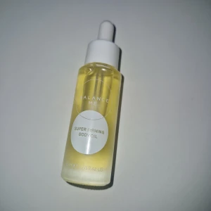 Body Oil - Oljan innehåller en blandning av oljor från enbär, bergamott och pelargon som ska förbättra blodcirkulationen och ge en uppstramande effekt.  Den är också rik på fettsyror, antioxidanter och vitaminer från jojoba-, vetegrodd- och macadamiaoljor för att jämna ut huden och förebygga celluliter.  Den är lämplig för alla hudtyper och är vegansk.  Oljan har en fräsch, träig doft med inslag av blommiga och fruktiga noter. 