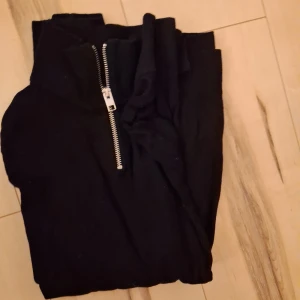 Svart half zip tröja Jack & Jones - Svart långärmad tröja från Jack & Jones med hög krage och silverfärgad half zip-dragkedja. Tröjan är i mjukt material och har en klassisk, enkel look som passar perfekt till jeans eller chinos. Nästan oanvända skriv till mig vid minsta funderingar. Säljer 1 för 150 och 2 för 250.