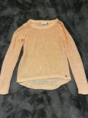 Persikofärgad stickad tröja från ONLY - Säljer en persikofärgad stickad tröja från ONLY. Säljer då den inte kommer till använding. Men väldigt fin!