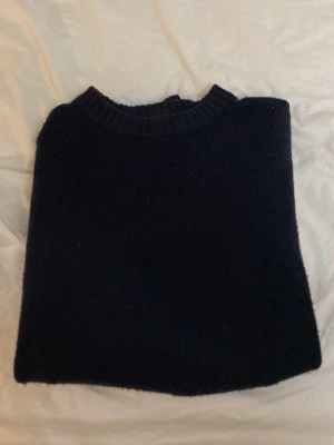 Mörkblå stickad tröja unisex - En enkel och stilren mörkblå stickad crewneck tröja från Jack & Jones Perfekt för kyliga dagar och funkar till det mesta i garderoben. Klassisk passform och mjukt material. 