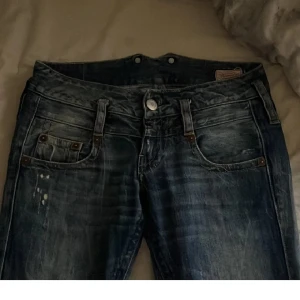 Blå bootcut jeans med slitningar - Snygga blå jeans med bootcut passform och slitna detaljer. Köpte på plick men dom passa inte. Skriv privat innan ni köper.