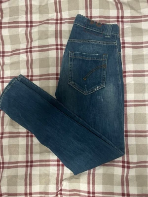 Dondup jeans (prisförslag) - Säljer ett par blå Diesel Jawnax jeans i storlek 31. Jeansen har klassisk femficksdesign, snygga slitningar och kontrastsömmar. Materialet är mjukt jeans-tyg som sitter skönt och har en modern passform.