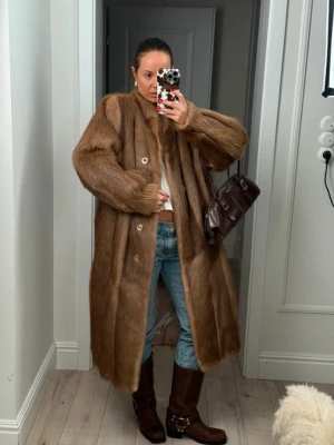 Vintage pälsjacka  - Vintage äkta pälsjacka (tvättbjörn) från polen. Inga defekter/hål och är i perfekt skick. Jackan är 116cm lång och mycket varm. Strl S-L. jag är strl s/m och den ger mig en lite oversized look.