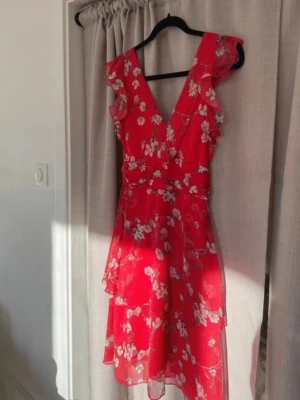 Flower Dress - Nelly - Använd en gång därav säljer jag denna pingla.  Skriv om du vill se bilder från hemsidan!❤️ Försluts med dragkedja samt hyska och hake baktill Fodrad - inte så den blir varm men så den inte är genomskinlig.