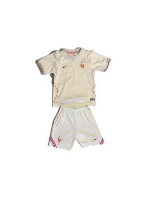  Nike fotbollsställ Frankrike - OBS Xs fast känns som xxs Säljer ett vitt fotbollsställ från Nike med Frankrikes landslagsmärke. Setet består av t-shirt och shorts med röda och blå detaljer samt Dri-FIT-material för bra ventilation. Perfekt för träning eller match. Tricolor-detaljer på ärmar och benslut. 