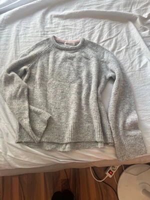 Ljusgrå stickad tröja - Säljer pågrund av att den e för liten. Har använt ganska många gånger.