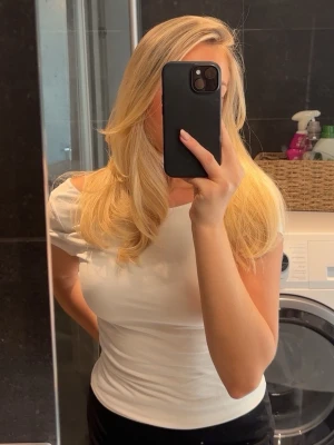 Soft touch low back top från Gina Tricot - Snygg vit topp med korta ärmar och en djup, öppen rygg. Toppens passform är tight och den är tillverkad i ett stretchigt material som sitter skönt mot kroppen 🩷