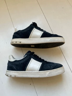 Valentino Flycrews Marinblå 37 - Säljer ett par feta Valentino Flycrews i marinblå färg. Det saknas 1 nit och mockan är i ett helt okej skick, utöver det så är skon i ett mycket bra skick. Skorna har mycket liv kvar. Tveka inte på att fråga! Storlek 37 men kan passa 36/38 beroende på passform. 
