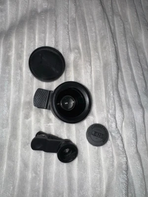 Linskitt till mobil & digitalkamera - Säljer ett set med kameralinser som enkelt kläms fast på din smartphone, surfplatta eller mindre digitalkamera. Perfekt för dig som vill ta mer kreativa bilder!   Fish eye lens 180° ger en häftig, rundad vidvinkeleffekt.   0.45X Wide Angle lens with Macro, för landskapsbilder eller extrema närbilder.   De är använda några gånger och det förekommer lite repor på glasen.   80kr för båda. Säljer dem inte separat.