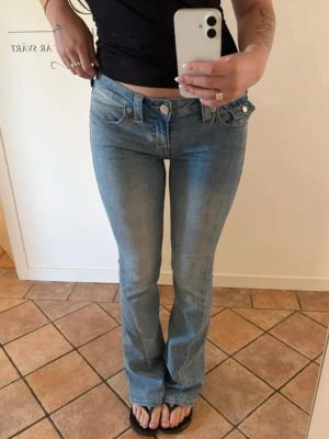 True religion Jeans  - Säljer ett par true religion jeans!  Köpta här på Vinted men blev tyvärr för stora för min lillasyster.  🩷 Dom är i super fint skick det enda är att det är ett hål på ena benet nertill och pågående hål på andra benet men inget man lägger märke till. Ser ut som att det är en del av jeansen!     Modell: Joey  Low rise Flare  Strl: 26  