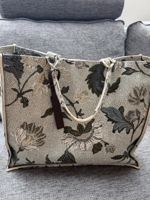 Ceannis shoppingväska - Snygg shoppingväska i tyg med Ceannis klassiska mönster. Väskan har två handtag och en fyrkantig form, perfekt för att bära med sig allt man behöver. Aldrig använd.