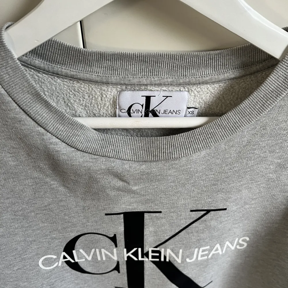 Säljer denna gråa sweatshirt från Calvin Klein då den inte kommer till användning mer. Den är använd en del men skicket är bra. . Tröjor & Koftor.