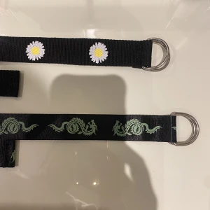 Bälte   - Säljer dessa två långa bältena med spännband. Endast använd typ två gånger.  Den ena är svart med blommor på och den andra är svart med gröna kinesiska drakar på. Köper du båda så blir det billigare.  Båda: 100 kr  Annars 60kr/st  