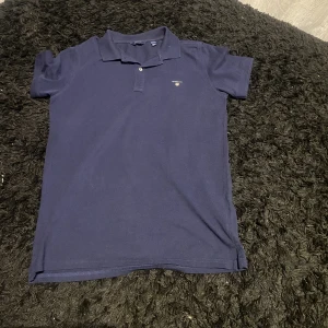 Gant piké  - Gant pike i färgen marinblå har Andvänt den typ 2 gånger nypris på denna ligger på ungefär 899kr mitt pris 210kr schik 10/10