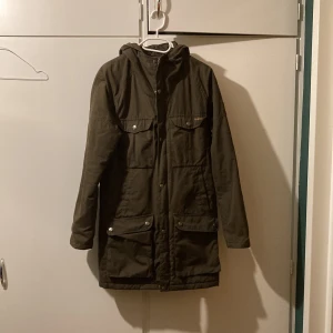 Lång fjällräven jacka  - Lång Brun fjällräven jacka. Den är i nyskick och oanvänd. Jättefin jacka. Kom privat för fler bilder