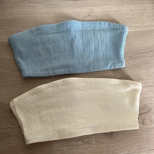 Bandeau toppar - 2 st bandeau toppar: NA-KD x Hanna Schönberg. Storlek L (små i storleken, denna storlek pga större byst). Får båda två i samma pris. 