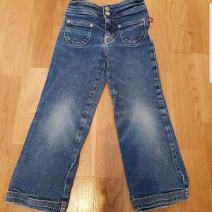 Blåa barnjeans från åhlens i storlek 98. Har två framfickor, dragkedja och tryckknappar.