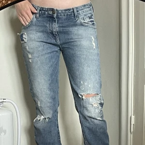 Lågmidjade jeans  - Lågmidjade jeans från zara med slitningar, lite oklar storlek men jag brukar ha 34/36 och de ligger på höften på mig