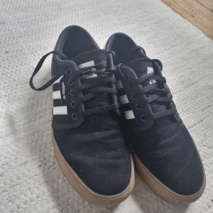 Black low Adidas sneakers  - Bought two years ago, been used a few times but still in good condition. Don't use them anymore.