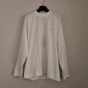 Acne Studios long sleeve white tshirt. New condition! Green mark in label because bought at sample sale, see 2nd photo. Round Acne Studios patch front. Oversized fit