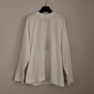 ACNE STUDIOS  - Acne Studios long sleeve white tshirt. New condition! Green mark in label because bought at sample sale, see 2nd photo. Round Acne Studios patch front. Oversized fit