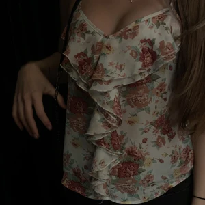 Volang linne - Ett rosa blommigt linne med volang, från bikbok. Storlek XS. Säljer pga den kommer aldrig till användning. Använd ett par gånger, bra skick. Nypris 150kr.