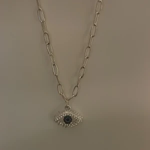 Halsband - Snyggt halsband med ett blått öga på. Är i bra skick🫶 Kontakta mig om ni har några frågor<3 Frakten är 17kr