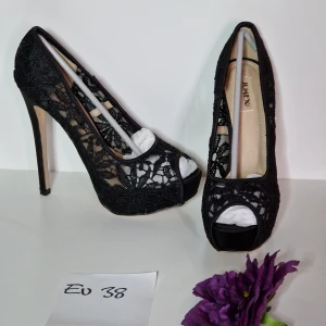 Romantiska pumps i svart spets strl 38 - Romantiska pumps i spets Klackhöjd ca 14 cm Platå ca 3,5 cm Helt nya och oanvända!