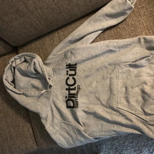 Dirtcult Hoodie - Hoodien är i använt skick se 2 bilden. Annars i bra skick inga fläckar. Ganska liten i storlek.