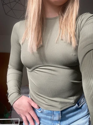 Grön långärmad  - Superfin långärmad med detalj under bröstet, säljer då den är för liten. Sparsamt använd