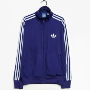 Adidas zip jacket - Intressekoll! Funderar på att sälja denna adidas zip up. Använd men funkar fint och utan defekter. Superfin med ljusblå ränder resten är lila. Lånade bilder. Strl L men passar alla ifall man vill ha den oversized. Kontakta mig vid minsta lilla fundering💜