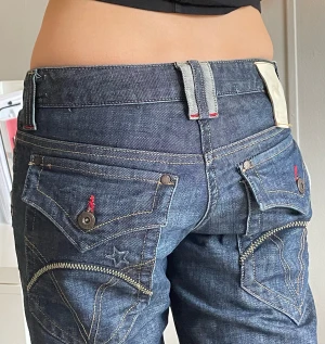 coolaste flare lågmidjade jeansen 🍀 - GRYMMA jeans jag säljer då de tyvärr var för korta för mig (173). Modellen är 169 :) Flare, lågmidjade och så många coola detaljer som inte fick plats på bilderna. DMa för fler bilder på dem och alla detaljer 💕 kom m prisförslag