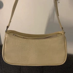 Liten väska  - En nästan helt oanvänd väska ifrån moki med silvriga detaljer, köpt för ca 1 år sedan, jättebra skick. 