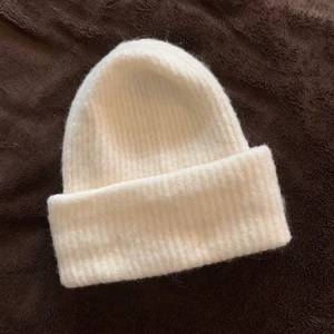 Vit mössa - Vit mössa från Åhléns, oanvänd men inga lappar kvar🤍 Supermjuk och mysig! Eftersom att flera var intresserade kör vi budgivning från 70 🥰