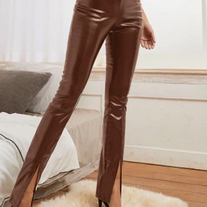 Bruna skinnbyxor - Super fina kostymbyxor i fejkat skinn från Shein. Tyvärr så måste jag sälja dem då de är för långa för mig som är 160. Sitter annars toppen bra. De är i storlek M men sitter som en smäck på mig som brukar ha S. De första två bilderna är lånade och ger mer en rättvis färg än vad sista bilden gör. Byxorna har en fin slita längst ner och resor i midjan som gör dem bekväma. 
