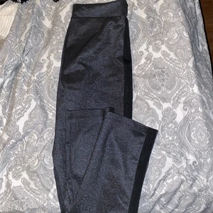 Kostym byxor - Kostym byxor i ett bra material. Glittrar och har en svart detalj på sidan. Lite vida vid fotleden och sitter tajt på bena resterande. 